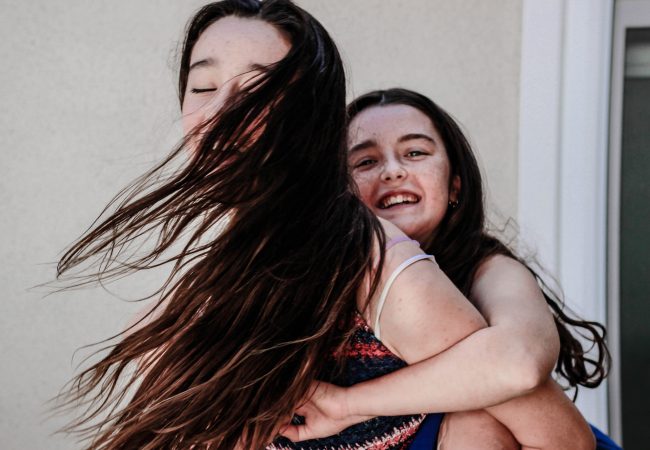 woman carryin girl on her back