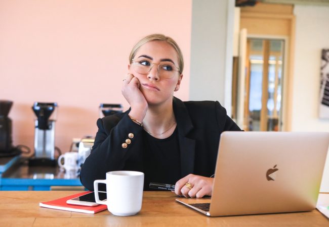 woman in black long sleeve shirt using macbook