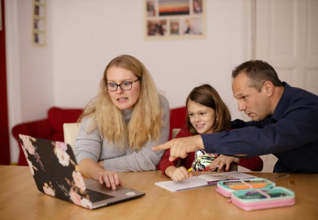 woman in gray long sleeve shirt sitting beside boy in blue sweater