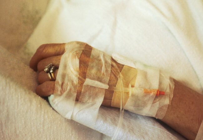 person wearing gold wedding band