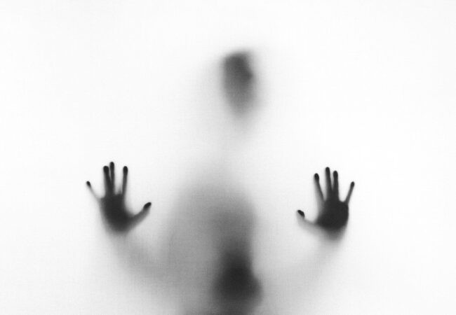 person behind fog glass